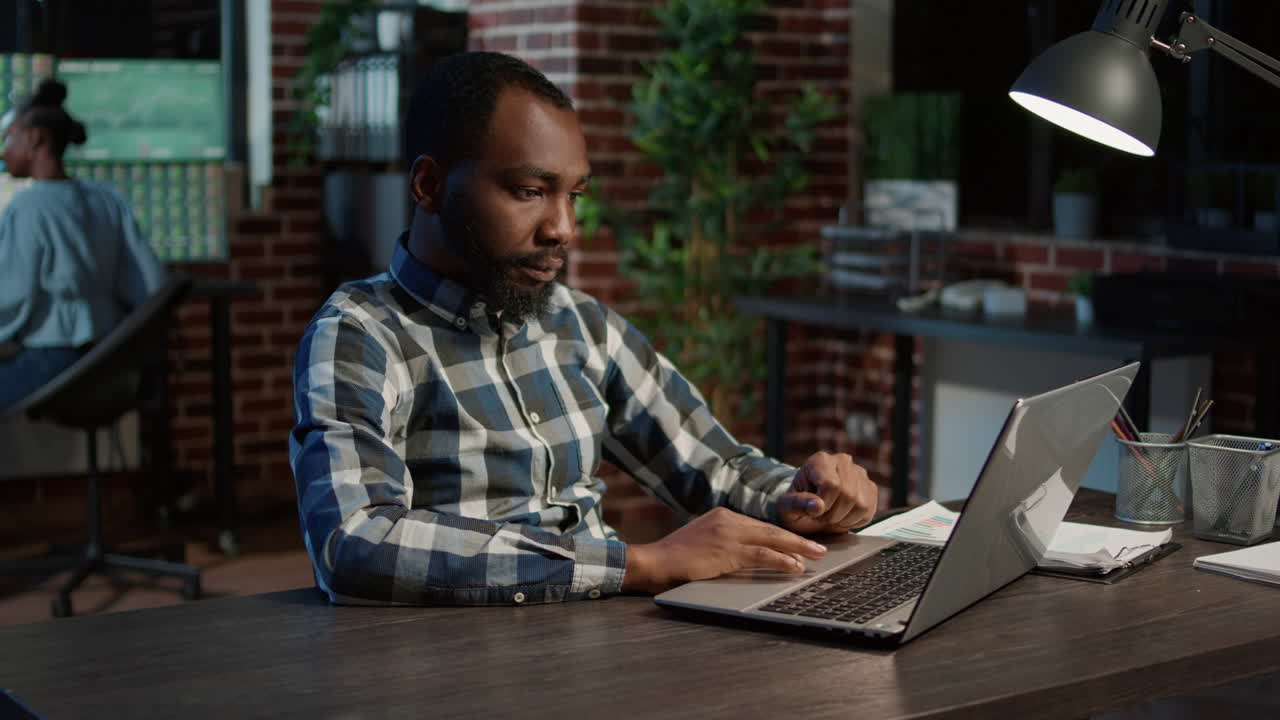 Financial analyst looking at laptop with exchange market sales