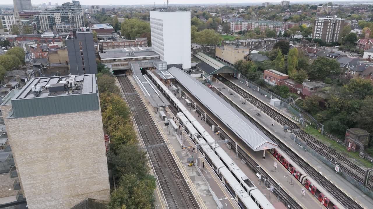 Elevated view of Ealing Broadway station with multiple trains at platforms, surrounding urban development and transport infrastructure, Ealing, London, UK