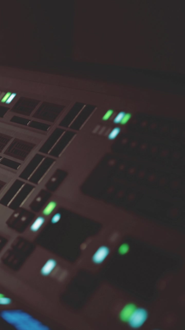 Control panel glows softly as music fills the room during late night session