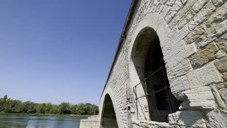 Bridge-in-Avignon-over-the-river-with-old-chapel-made-of-historic-stone-arches-in-good-weather