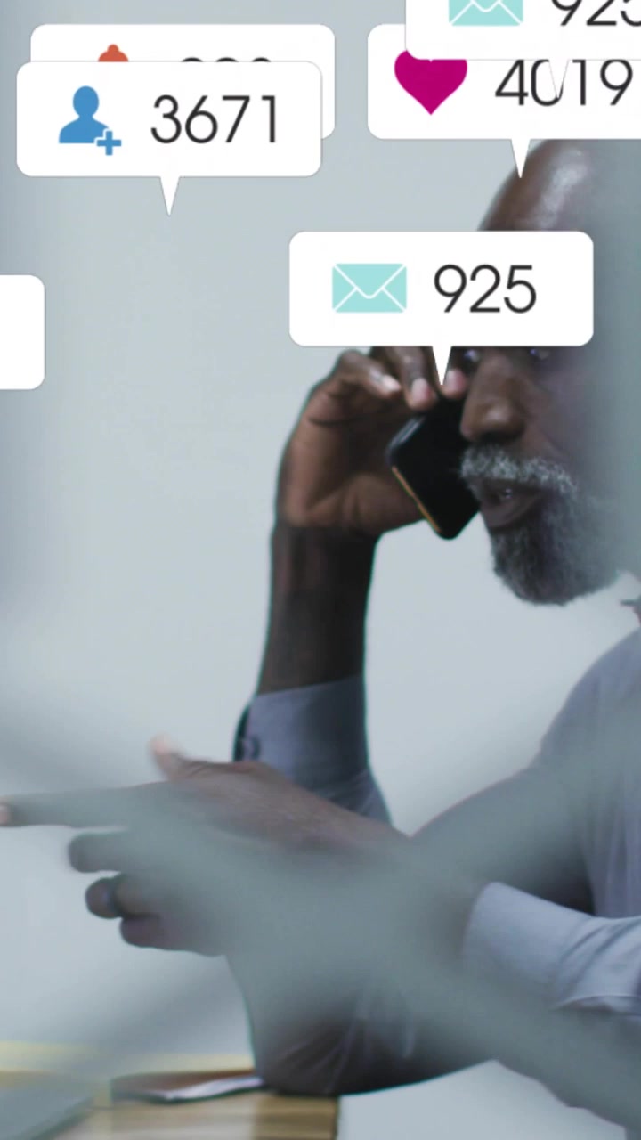 Vertical video: Man on phone speaking on business call causing social bubbles building across frame
