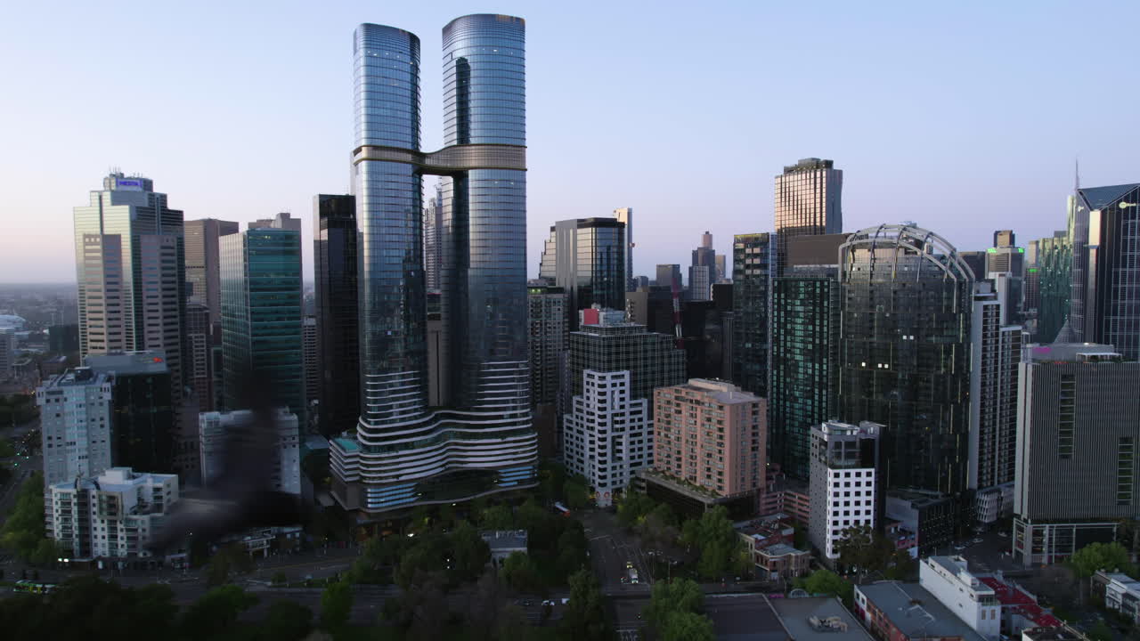 Aerial tracking shot of the north side of skyline of Melbourne, sunny morning