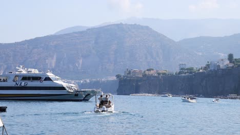 yacht and boats navigating near sorrento cliffs