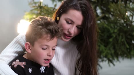 Small Children with their Family Near the Christmas Tree Family Values Concept of Christmas Holidays Small Children with their Family Near the Christmas Tree Family Values Concept of Christmas Holidays
