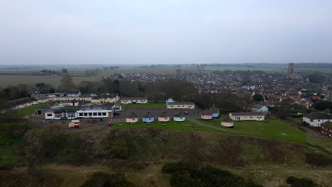 drone flies toward hermanus holiday park with countryside and village in view