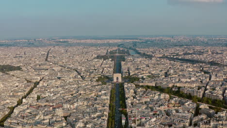 Dolly-forward-drone-shot-of-the-Arc-de-Triomphe-Champs-Elysees-Paris-golden-hour-sunset