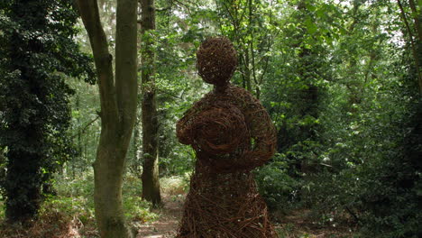 forest tree sculpture art in the woods with a mother and child