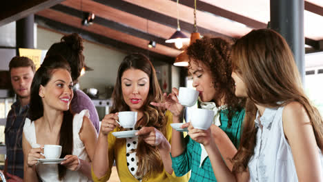 group of friends interacting while having coffee