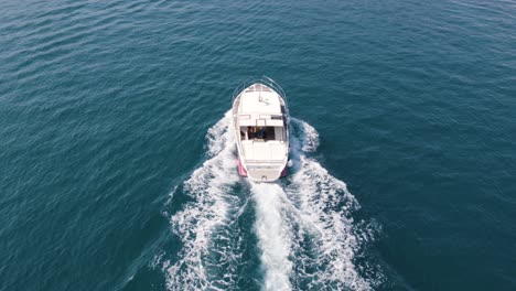 Aerial-tracking-shot-of-Motorboat-cruising-on-serene-Dubrovnik-waters