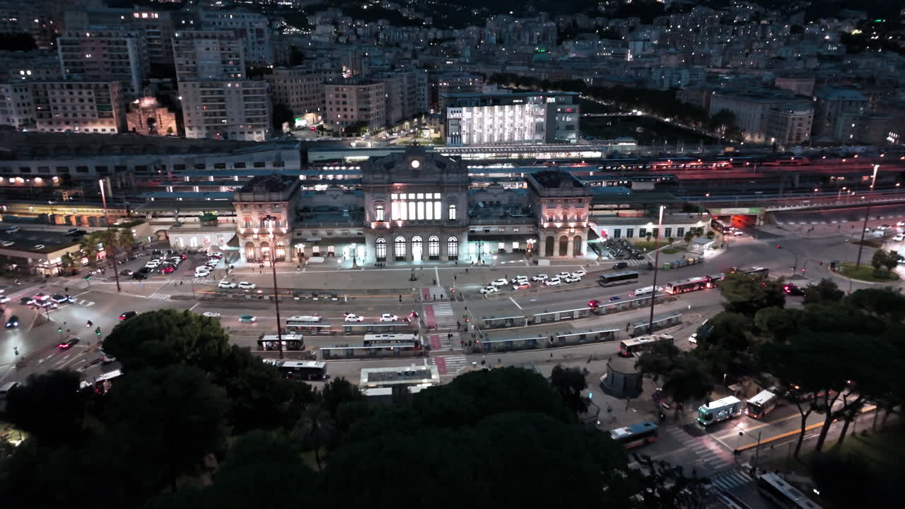 Iconic Brignole train railway station in Genoa at night, aerial pullback view