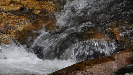 Agua-De-Río-De-Cocodrilo-De-Cascada-De-Montaña-Fresca-Y-Cristalina-Que-Brilla-Y-Fluye-Sobre-Rocas-Y-Guijarros-En-El-Fondo-En-Los-Jardines-Botánicos-Nacionales-Walter-Sisulu-En-Roodepoort,-Sudáfrica