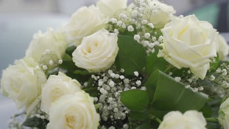closeup of a bouquet of roses with large white flowers and decorative elements for the wedding
