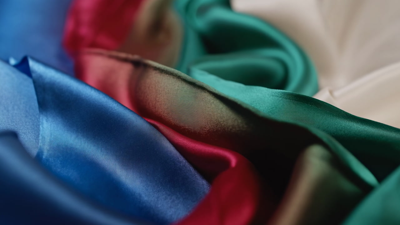 Closeup Colorful Satin Fabrics Glossy Drape, Atelier Draper Arranging Layered Swatches Under Soft Studio