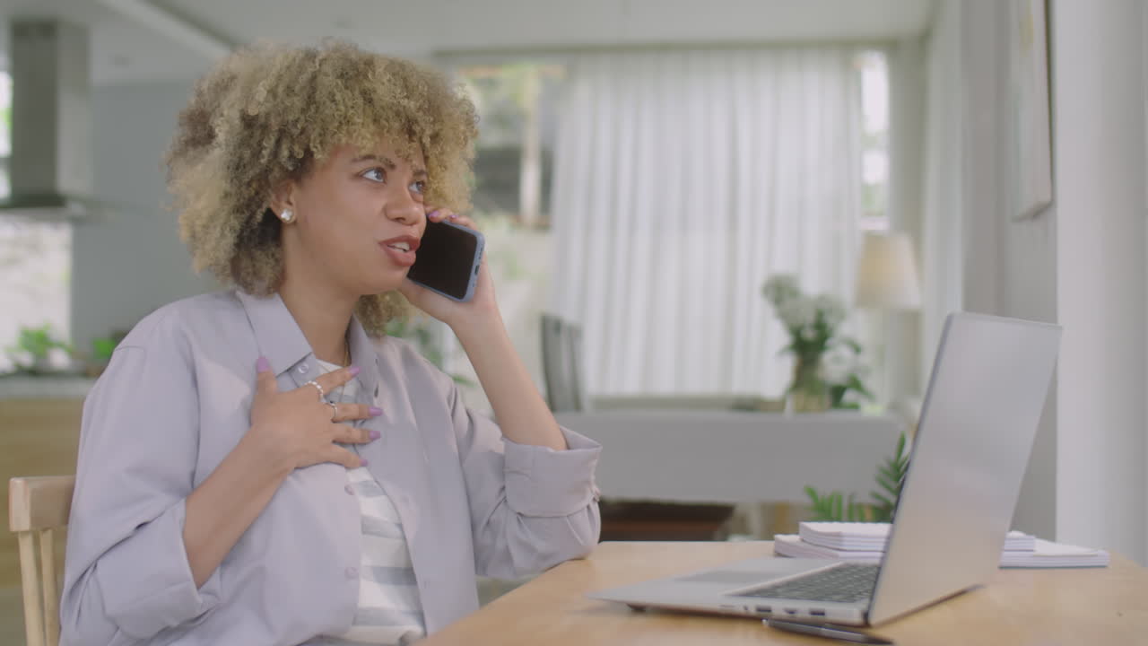 Woman Talking on Phone at Home Workplace