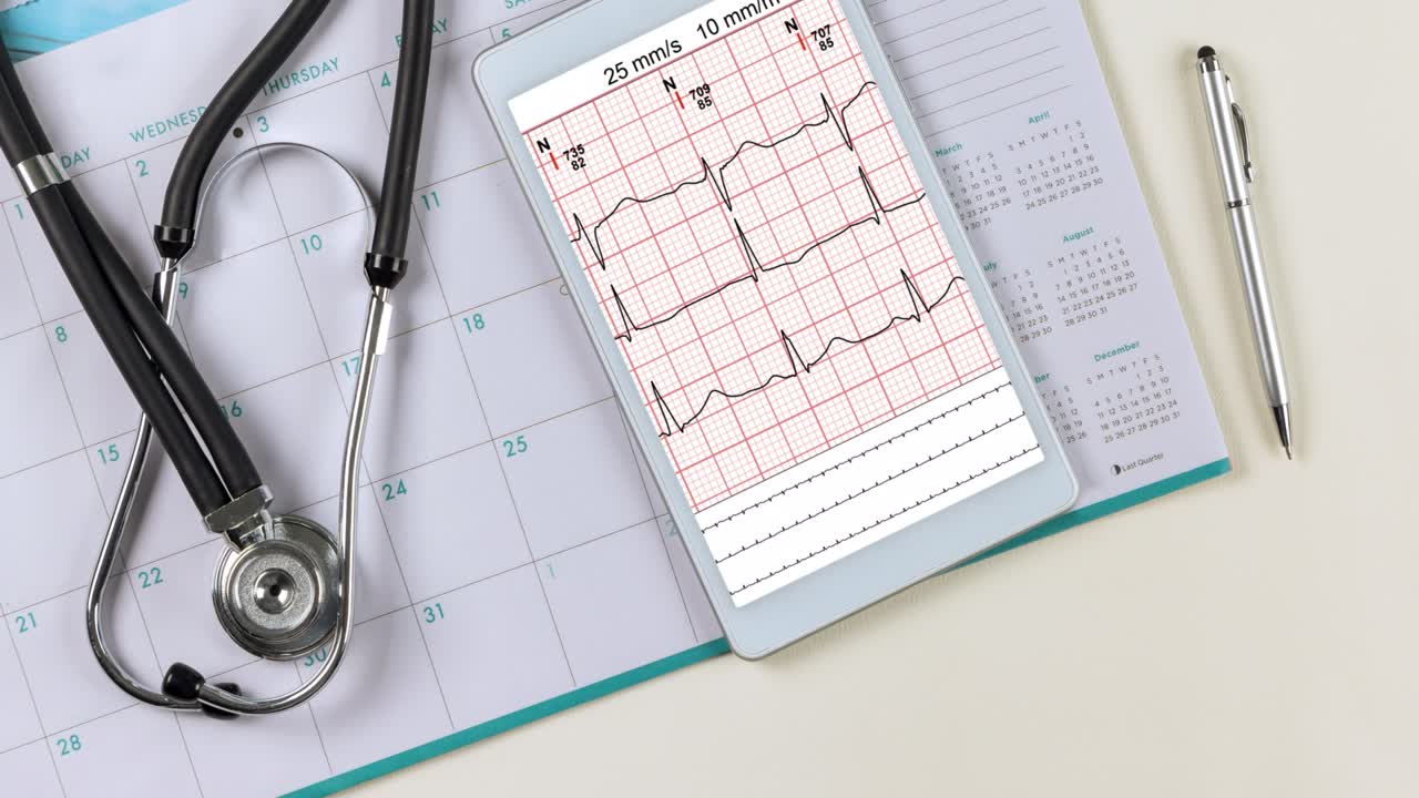 Doctor workplace with a stethoscope electrocardiogram heart rate readings