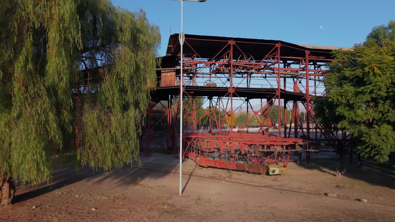 Old mining structures of Estación 1 Cable Carril among trees and mountains in Chilecito, La Rioja, Argentina
