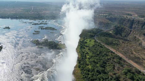 Aerial-Drone-View-of-Victoria-Falls-and-the-Rainbows,-In-Between-Zambia-and-Zimbabwe