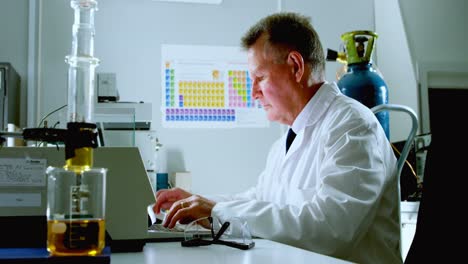 male scientist using laptop on desk 4k