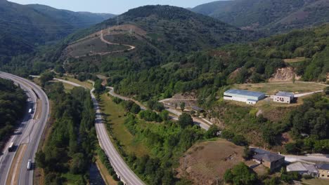 Aerial-view-of-highways-and-a-river-surrounded-by-mountains