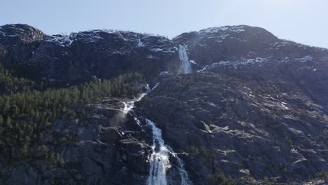 majestic norwegian forest mountain waterfall landscape upward looking to sky dolly right