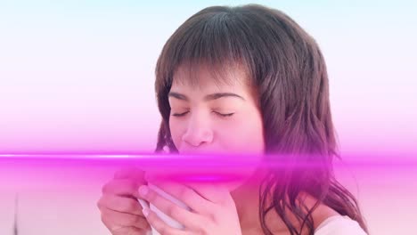 animation of light trails over biracial woman holding mug and drinking