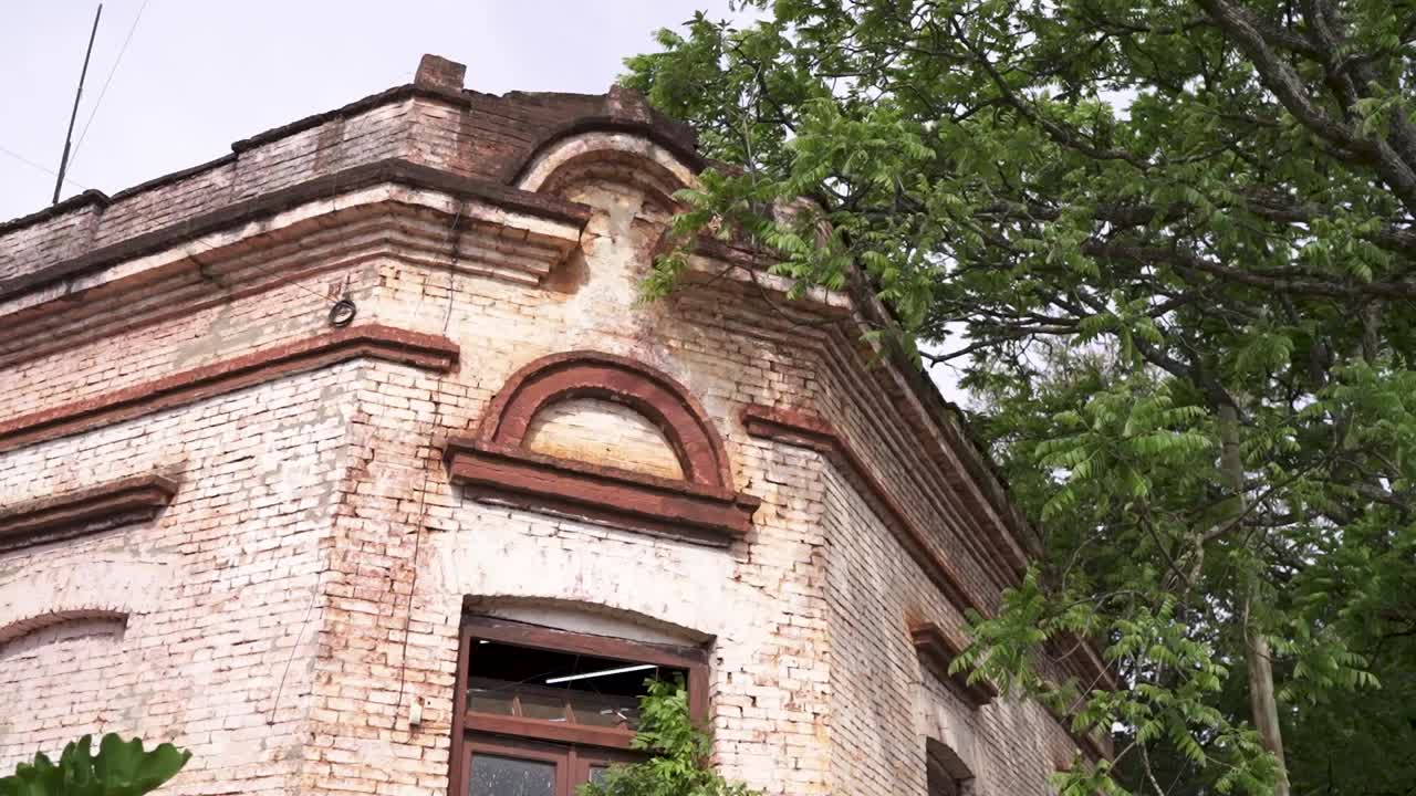 Old red brick construction building and its facade details in city environment