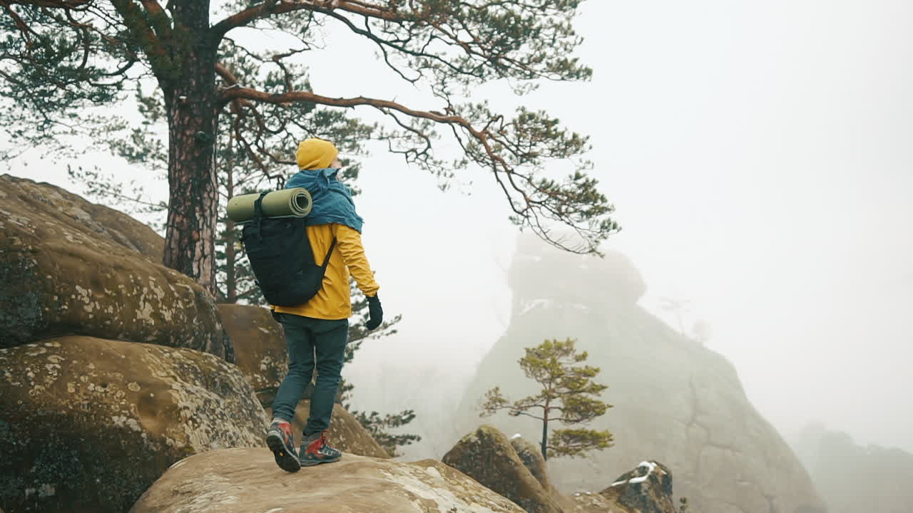 Man hiking and celebrating nature in the mountains