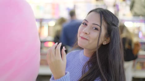 teenage girl eating cotton candy