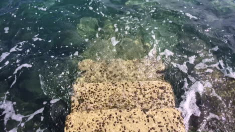 looking down some stairs that go down into the sea on a bright sunny day