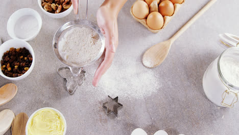 Woman-staining-flour-in-sieve-4k