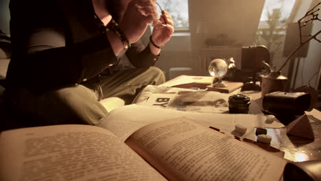 man reading old books at a study table