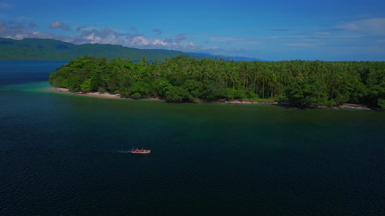 Fishing power boat Yuo Island beach shoreline remote pristine untouched tropical Mushi island coastline village Wewak Madang Cape Wom Papua New Guinea aerial drone PNG birds summer morning blue sky