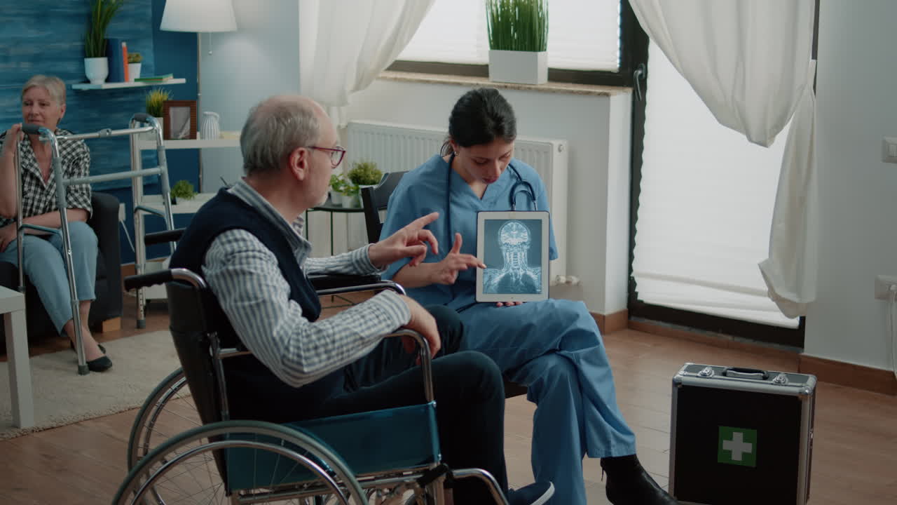 Nurse explaining osteopathy x ray on tablet to man