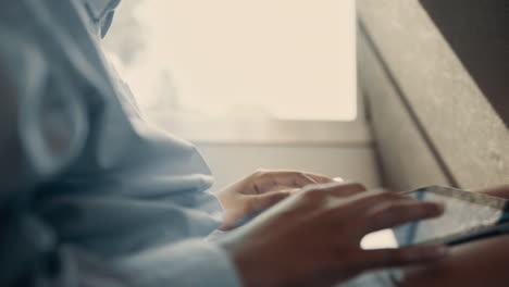 girl hands tapping tablet close up. smiling schoolgirls talking enjoying trip.