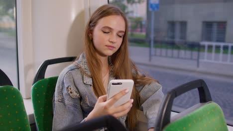 Tired-woman-citizen-playing-on-smartphone,-chatting,-texting,-falling-asleep-in-public-transport