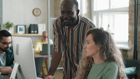 Black Man and Caucasian Woman Discussing Business Project on Computer