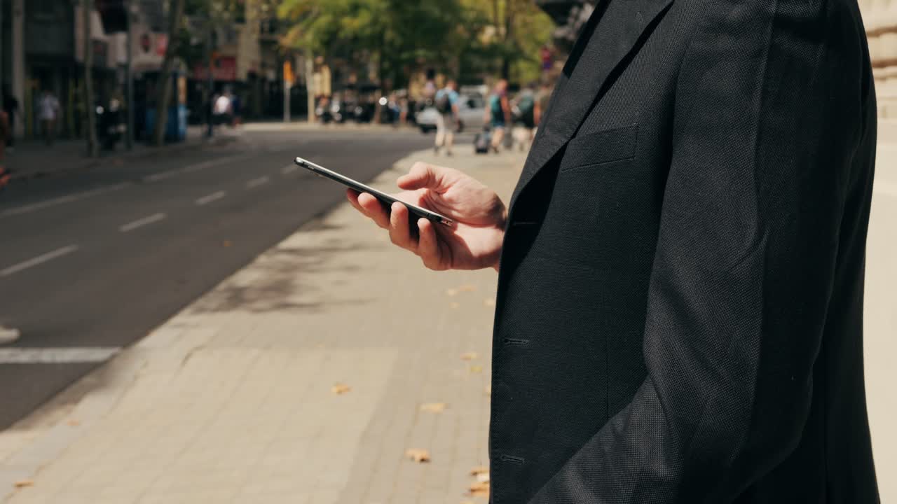Man using smartphone on city street