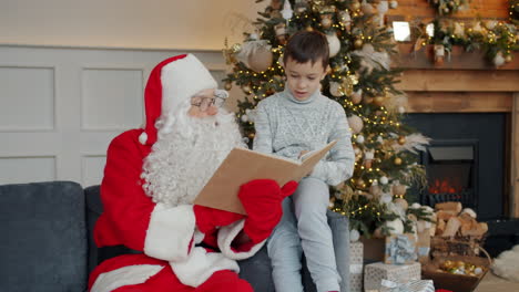 santa reading a book to a boy