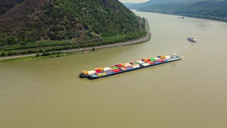 industrial barge freighter ship transporting cargo containers cruising river rhine, germany