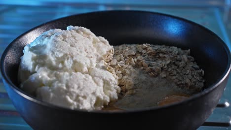 making healthy meal chicken and oatmeal with ingredients in a bowl