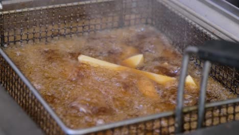 french fries boiling in slowmotion in a french food truck