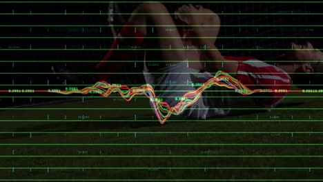 animation of graphs and data over caucasian soccer player suffering at stadium