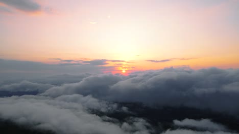 Aerial-view-of-sun-rising-above-the-clouds