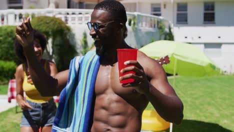 Diverse-group-of-friends-having-fun-and-dancing-at-a-pool-party