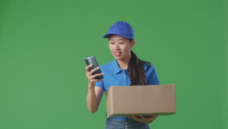 woman delivery person with package and smartphone