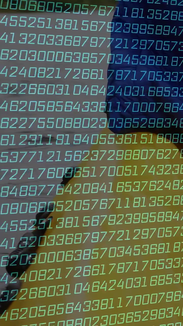 Vertical video: Man standing in profile while green digits scrolling, creating depth shift for tech