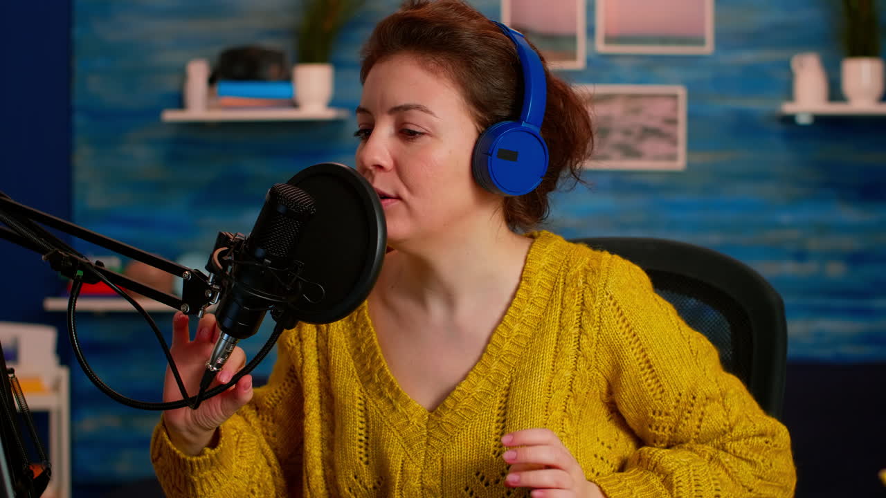 Woman recording video on camera in home studio