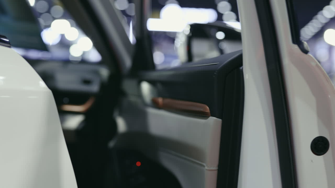 Opening a White Car Door at an Auto Show