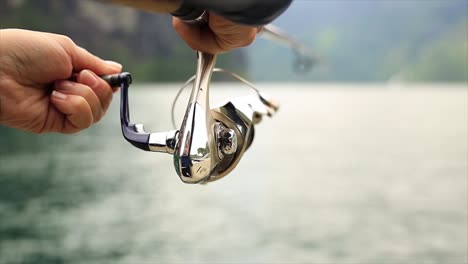 woman fishing on fishing rod spinning in norway.