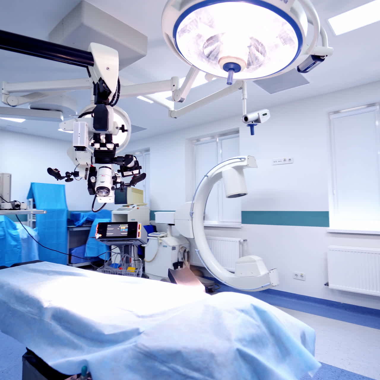 Modern operating room with new technological equipment. Light surgical room in the neurosurgical department. Camera moves around.